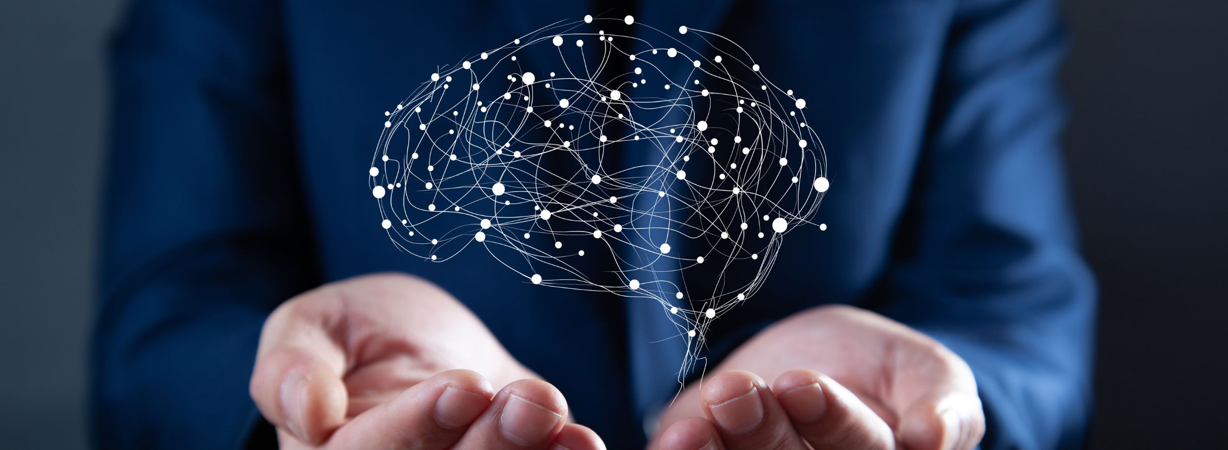 Businessman holding brain graphic